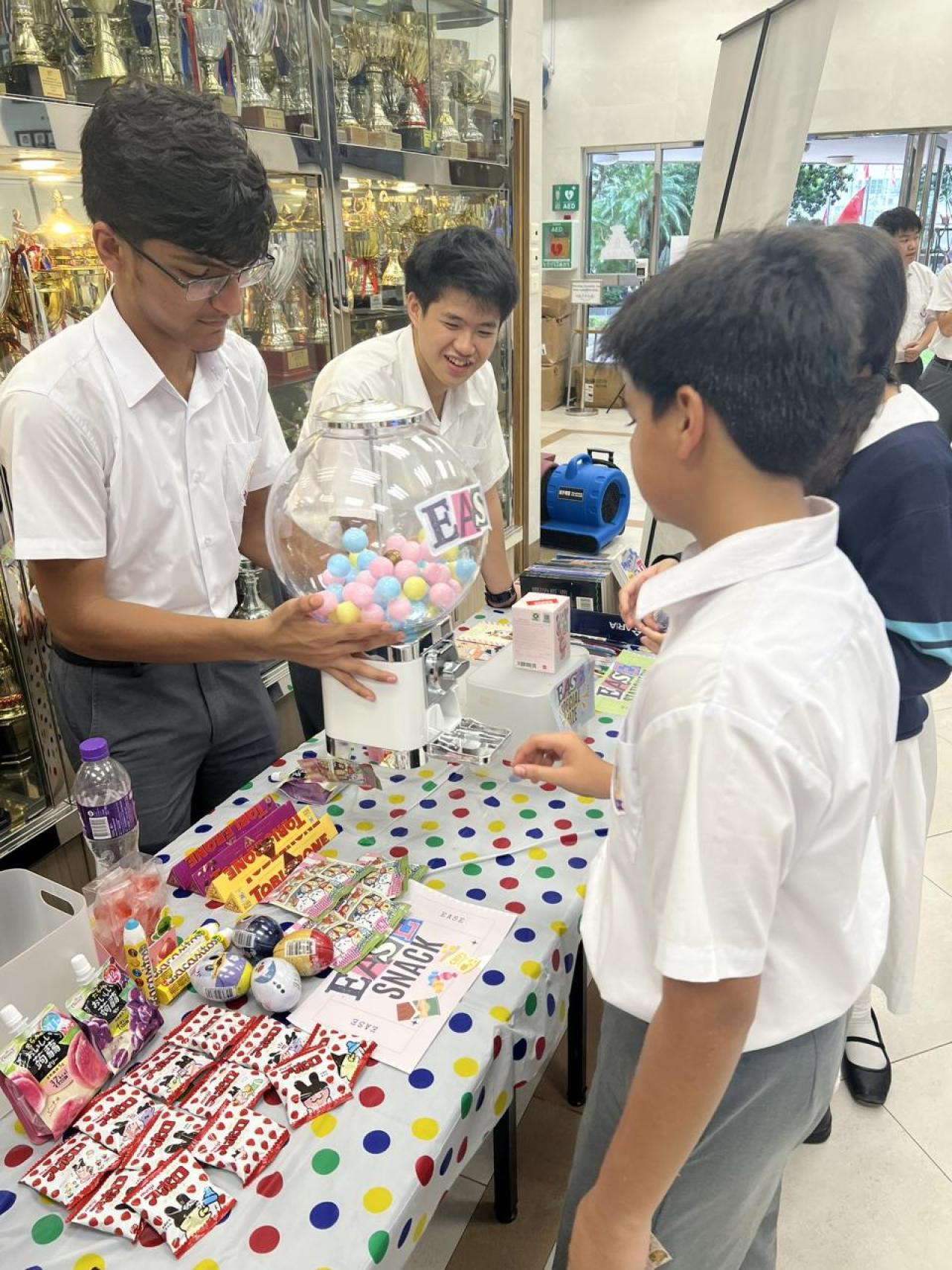 Students redeem prizes at the prize booth after collecting 8 EASE stamps.